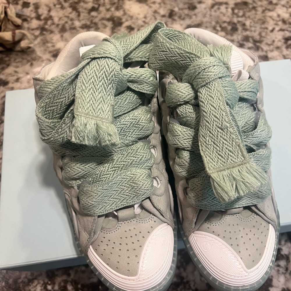 Sage Lanvin curb sneakers.
